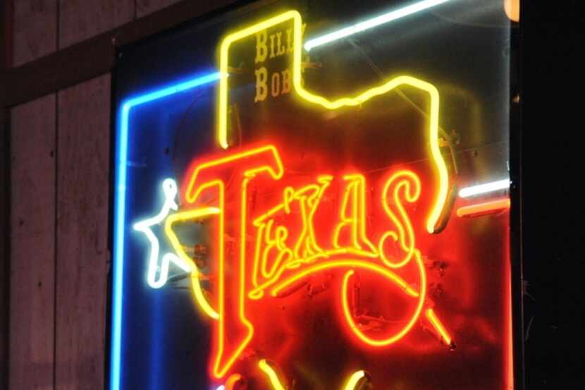 Neon sign hangs on the wall inside Billy Bob's Texas.