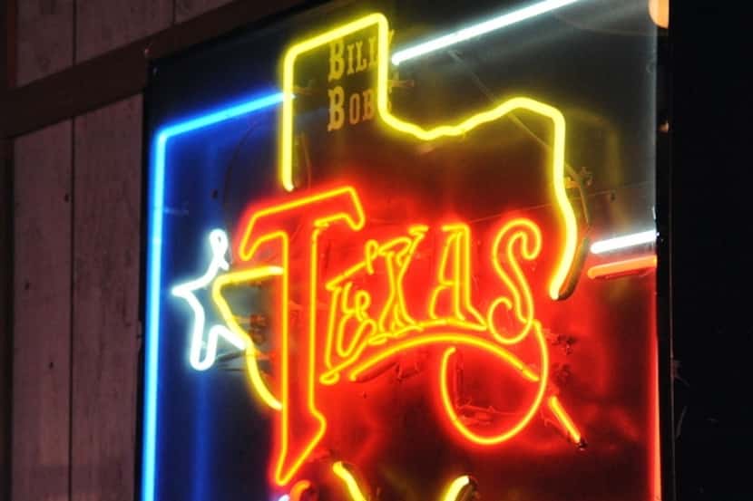 Neon sign hangs on the wall inside Billy Bob's Texas.