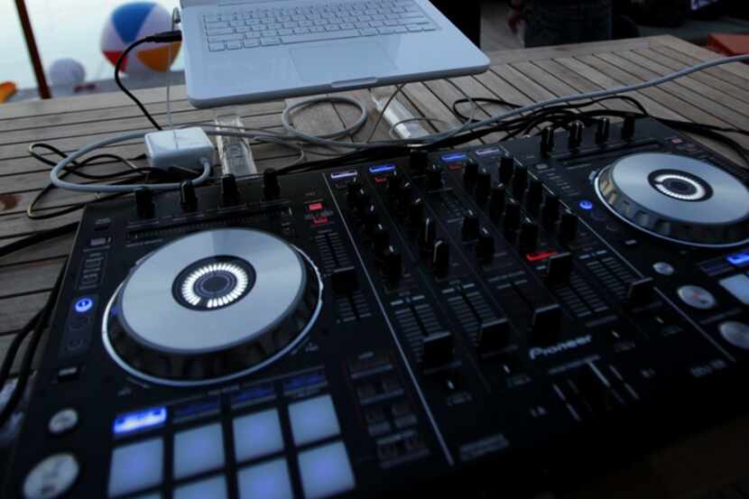 A DJ's equipment is set up near the rooftop pool of the NYLO Dallas hotel, now the Canvas...