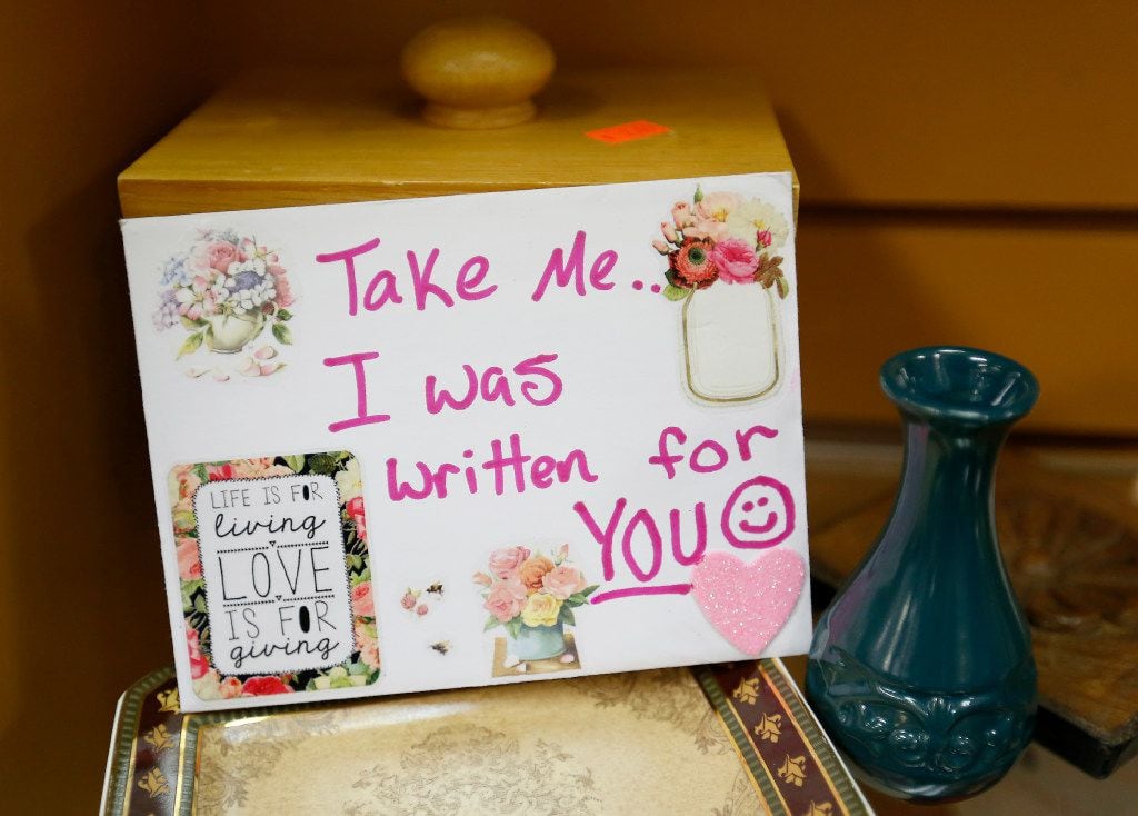 A card that Angela Joy Bailey wrote sits on shelves at The Coat of Many Colors store in...