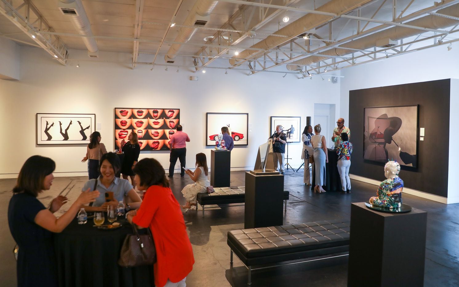 New York Life staff sip wine and look at art at the Samuel Lynne Galleries in Dallas on...