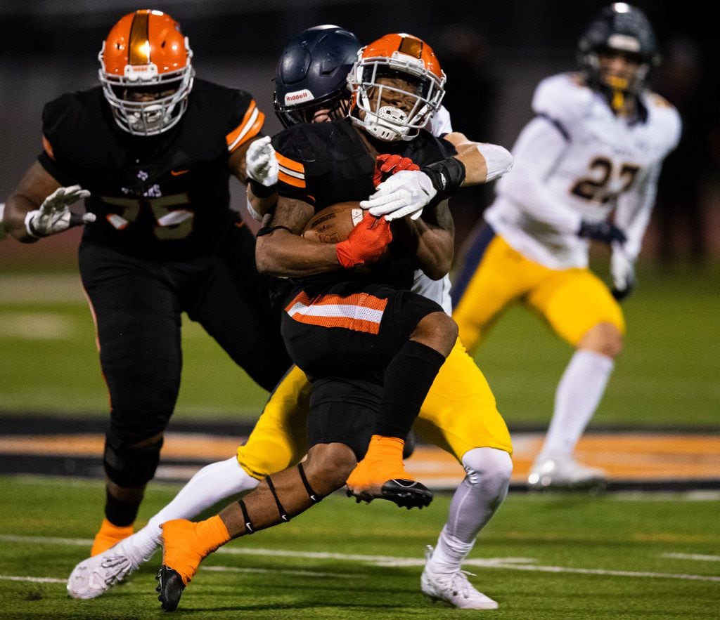 Lancaster running back DQ James (6) is tackled by Highland Park defensive back Cal Hirschey...