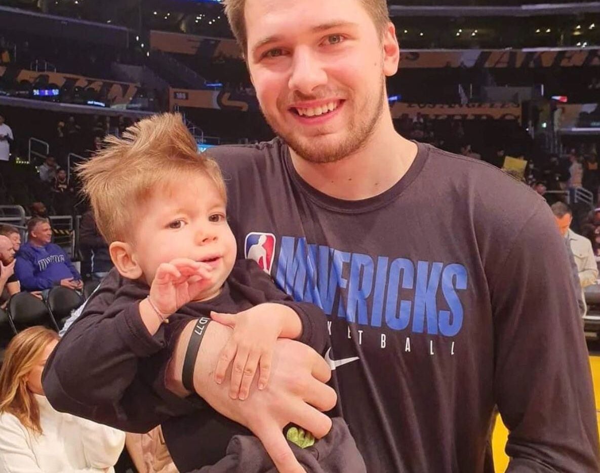 Luka Doncic holds Kris Zudich, the 22-month-old Slovenian boy with a rare genetic disease...