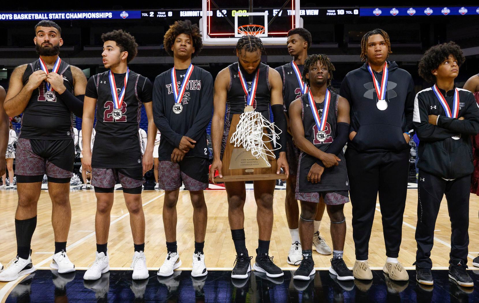 Mansfield Timberview guard Jared Washington (5) holds the state runner-up trophy after the...