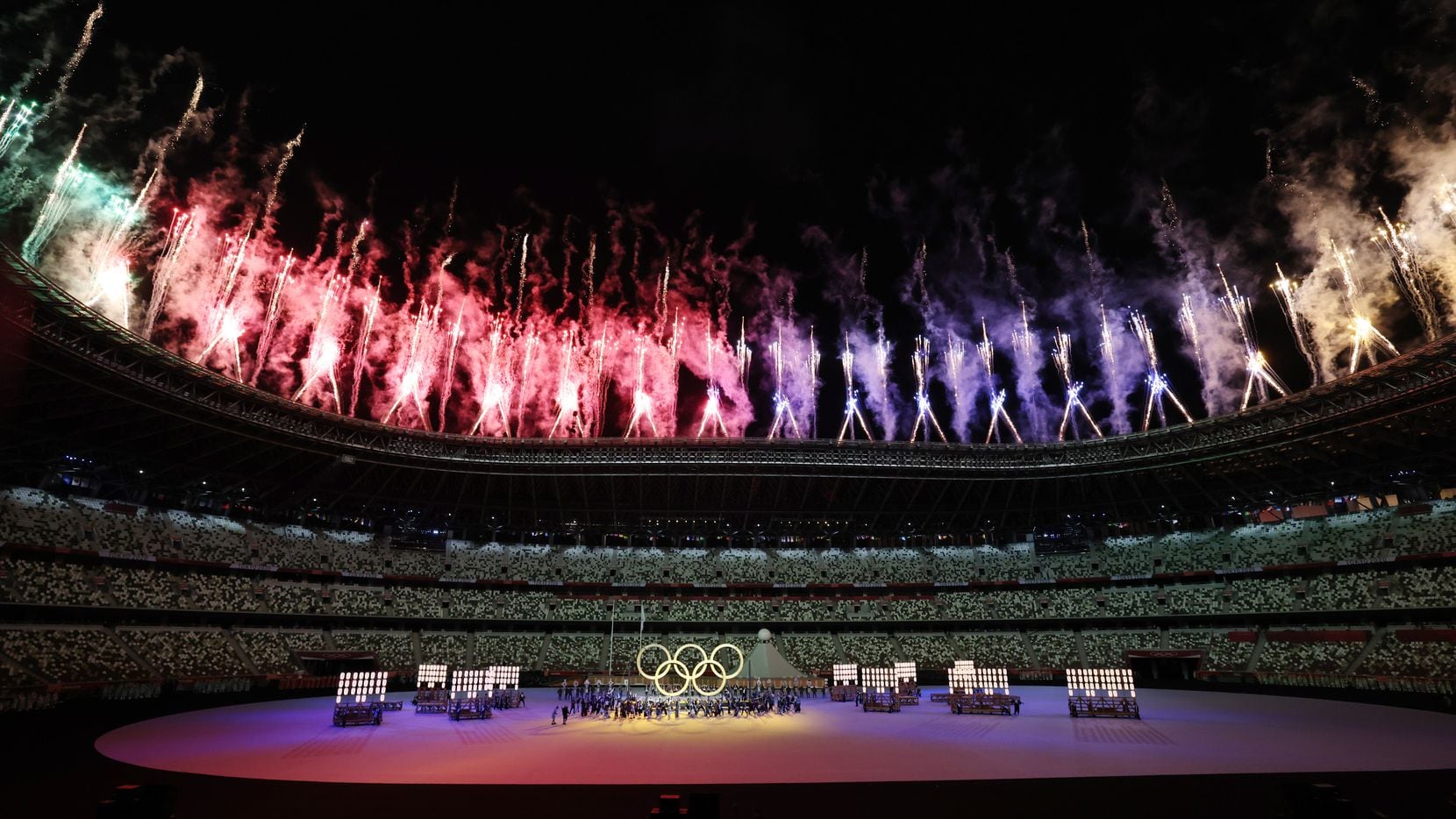Fireworks go off as the Olympic rings are shown during the opening ceremony for the postponed 2020 Tokyo Olympics at Olympic Stadium on Friday, July 23, 2021, in Tokyo, Japan.