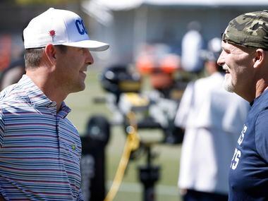 Dallas Cowboys defensive coordinator Dan Quinn (right) visits with Denver Broncos general...