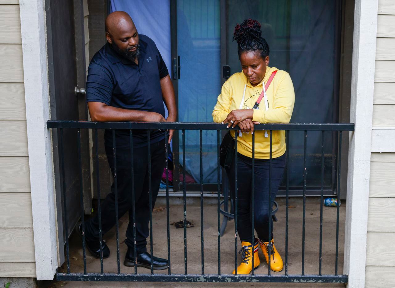 Home owners Michael and Latanya Benefield, during a portrait at their porch where water...