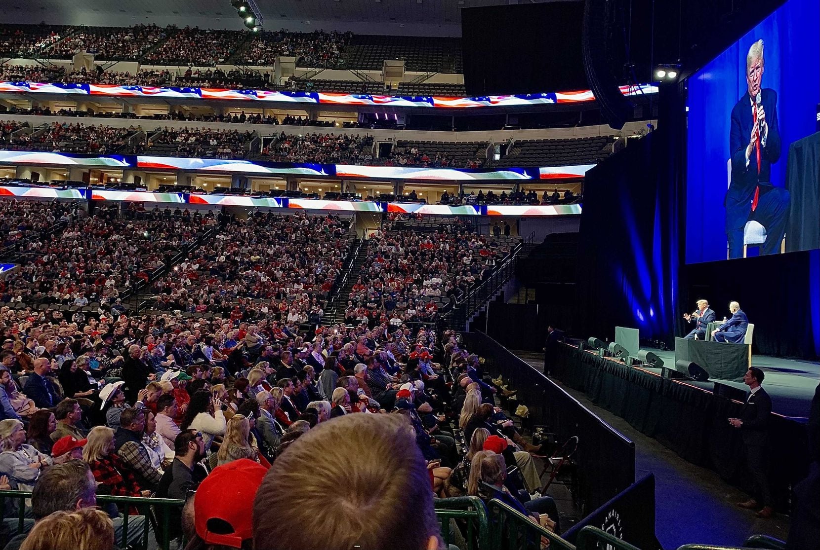Former President Donald Trump appears Sunday before the crowd at American Airlines Center in...