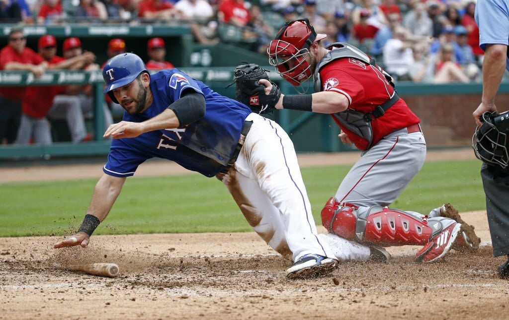 Texas Rangers first baseman Mitch Moreland (18) is called out sliding into home in front of...