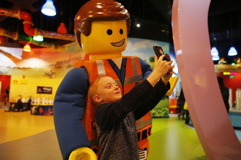 Zachary Peltonen takes a selfie with Emmet at Legoland Discovery Center at Grapevine Mills...