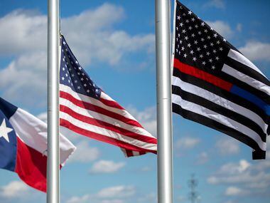 Flags at the Grand Prairie Police Department flew at half-staff Friday in memory of Officer...