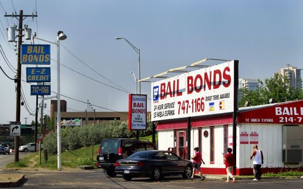 Bail bond offices advertise around-the-clock help on Riverfront Boulevard in Dallas.
