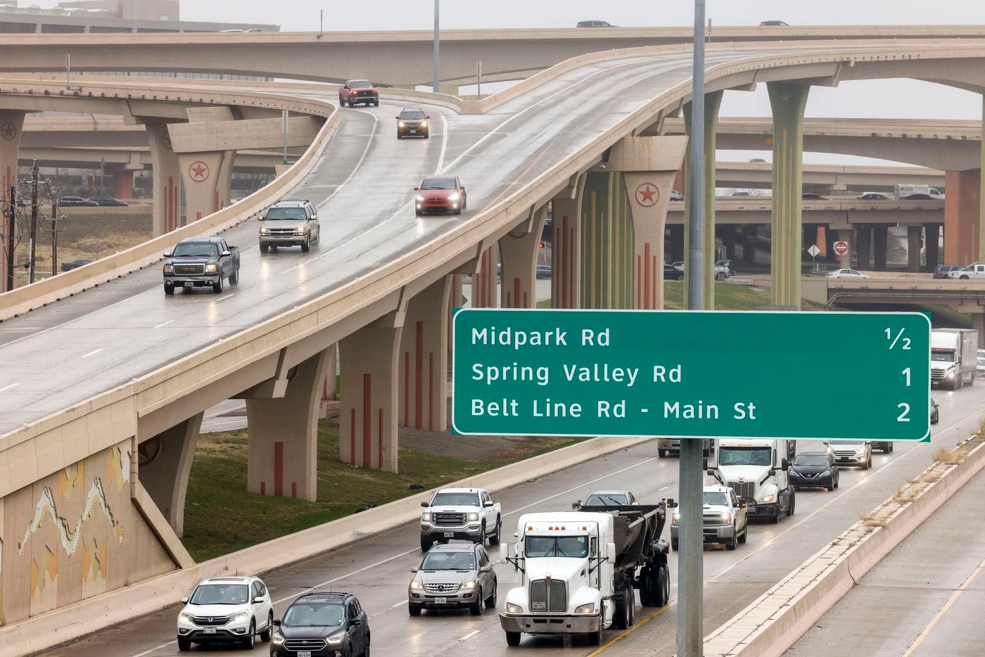 Motorists travel cautiously along southbound U.S. 75 through the High Five interchange at...