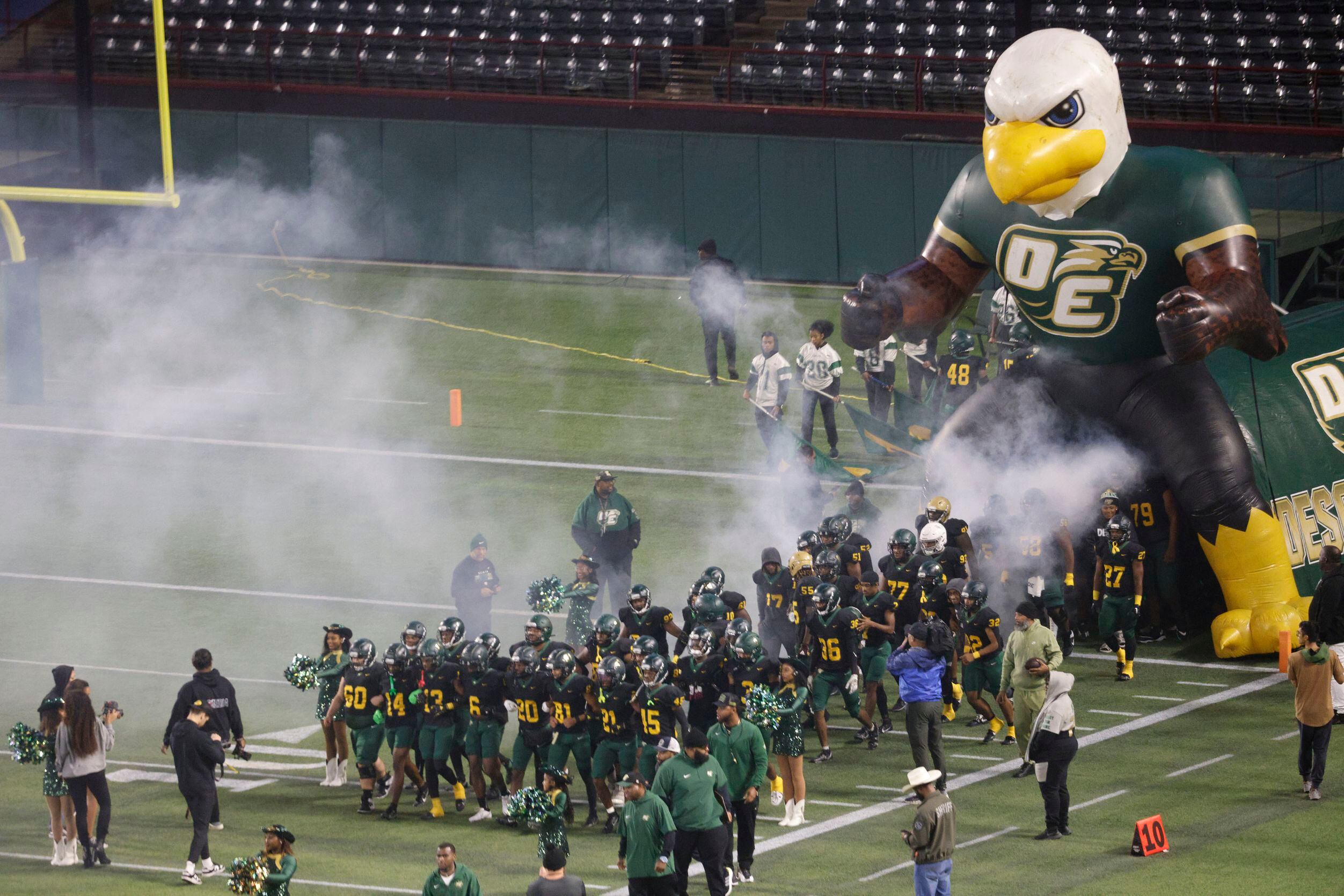 DeSoto players run out into the field before the first half of a Class 6A Division II...