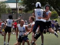 Hebron players Jack Autry (17), upper right, and Cobye Baldwin (11) jump for joy as they...