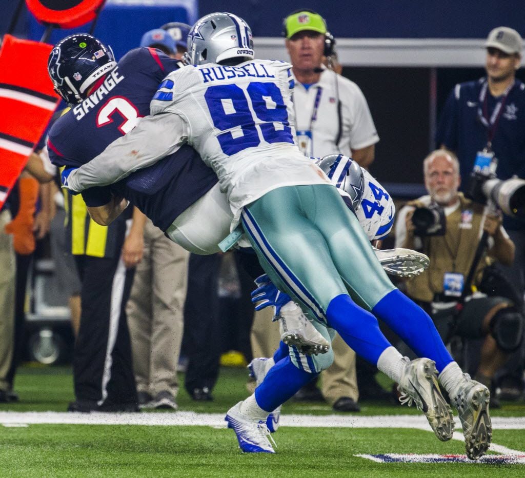Dallas Cowboys defensive end Ryan Russell (99) tackles Houston Texans quarterback Tom Savage...