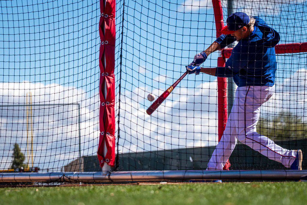 Texas Rangers infielder Ronald Guzman takes batting practice during a spring training...
