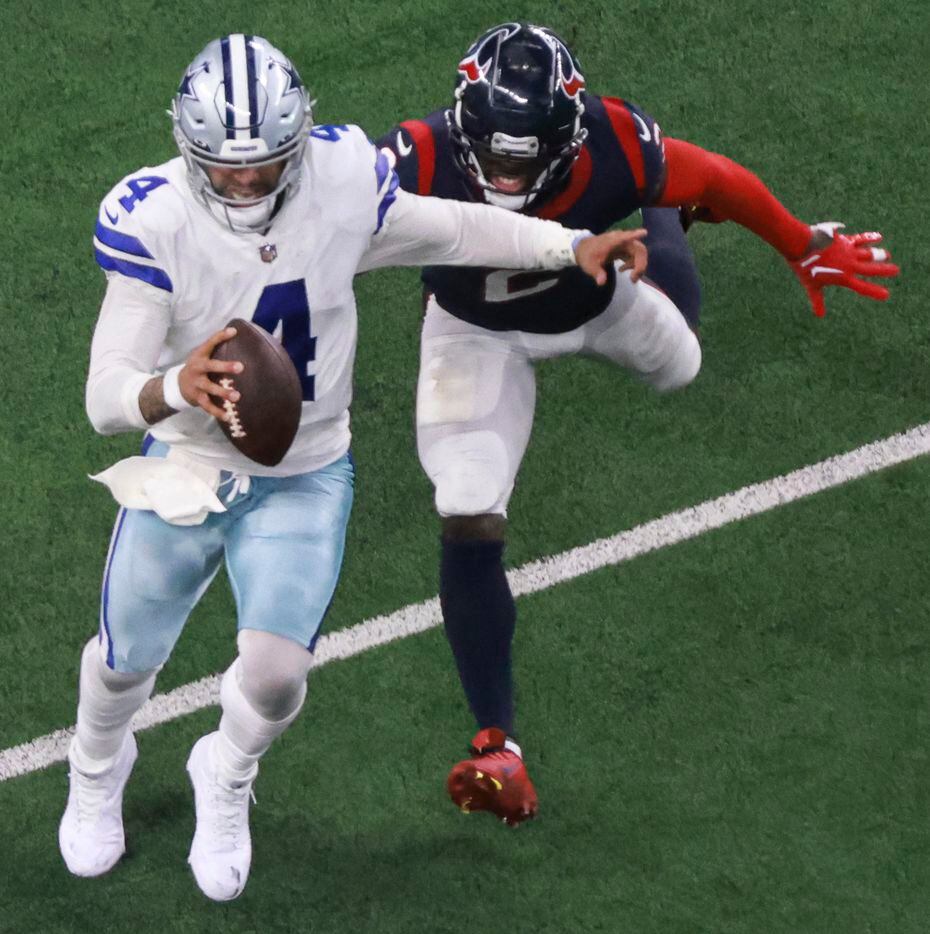 Dallas Cowboys quarterback Dak Prescott (4) runs the ball up the field as Houston Texans...