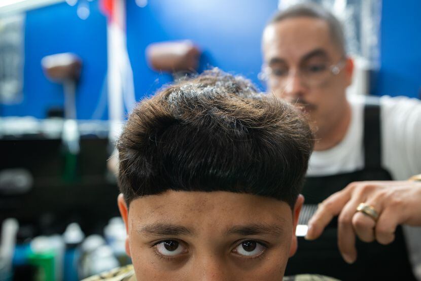 Brazilian urban indigenous youth gives haircut to other