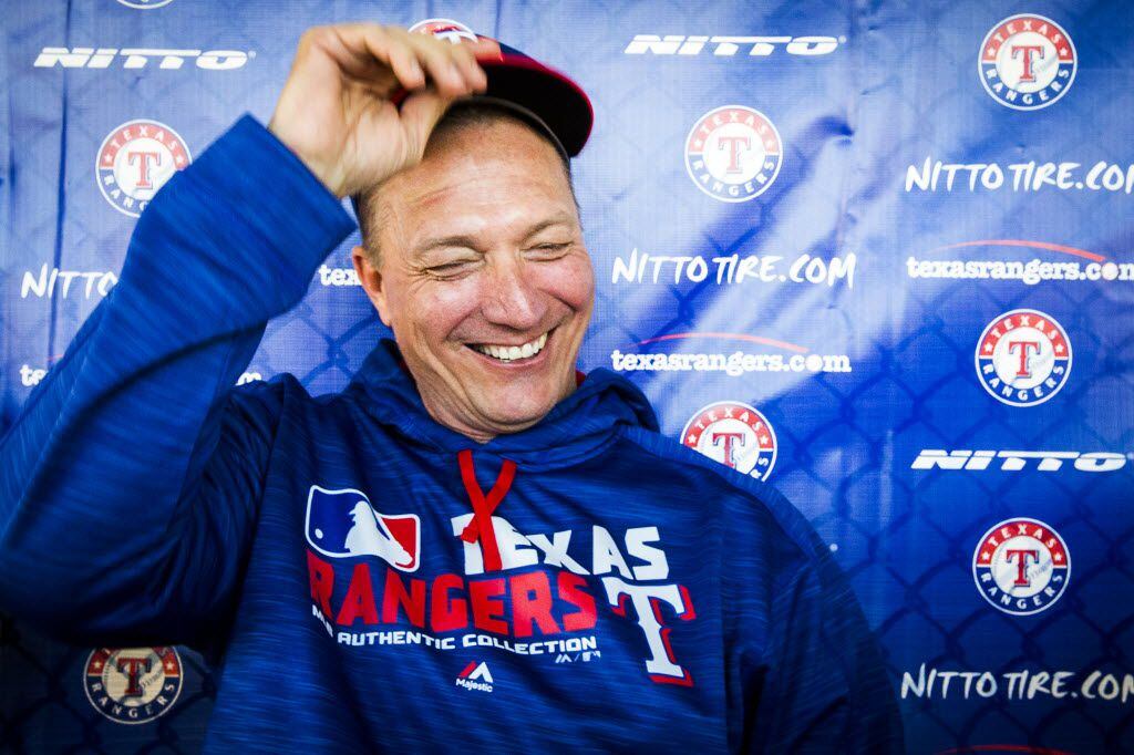 Texas Rangers manager Jeff Banister laughs as he sits down for an interview before a spring...