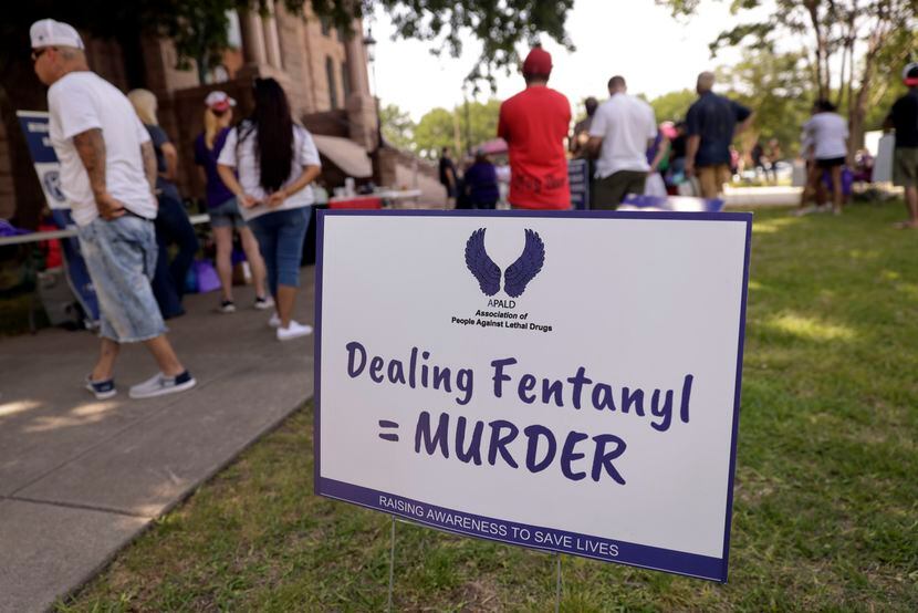A sign equates fentanyl poisoning as murder during the 3rd Annual Association of People...