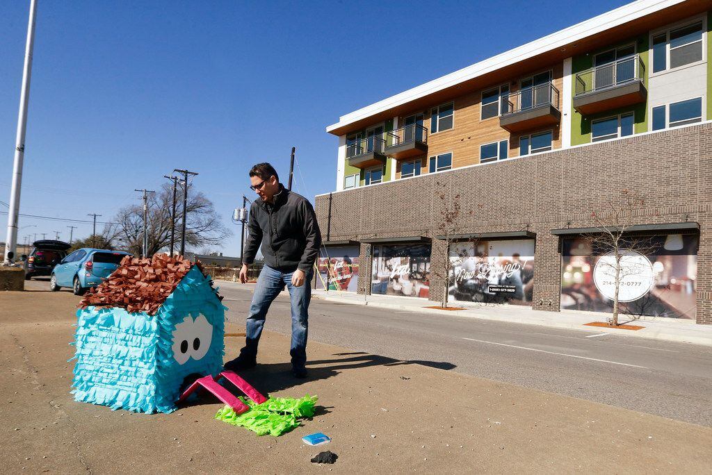 Dallas artist Giovanni Valderas places one of the pieces of his project called 'Casitas...