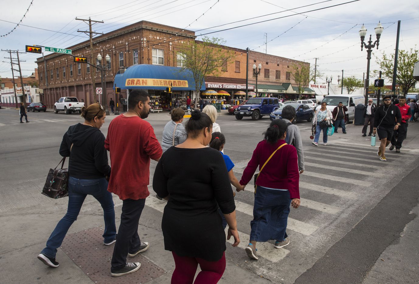 Shoppers, many of who will return into Mexico by the end of the day, walk along El Paso...