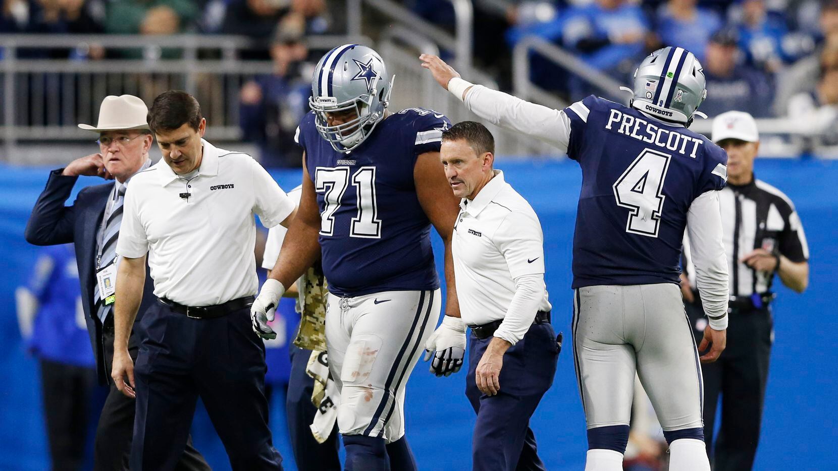 Dallas Cowboys quarterback Dak Prescott (4) taps Dallas Cowboys offensive tackle La'el Collins (71) as he walks off the field with the medical staff during the second half of play at Ford Field in Detroit, on Sunday, November 17, 2019. Dallas Cowboys defeated the Detroit Lions 35-27. (Vernon Bryant/The Dallas Morning News)