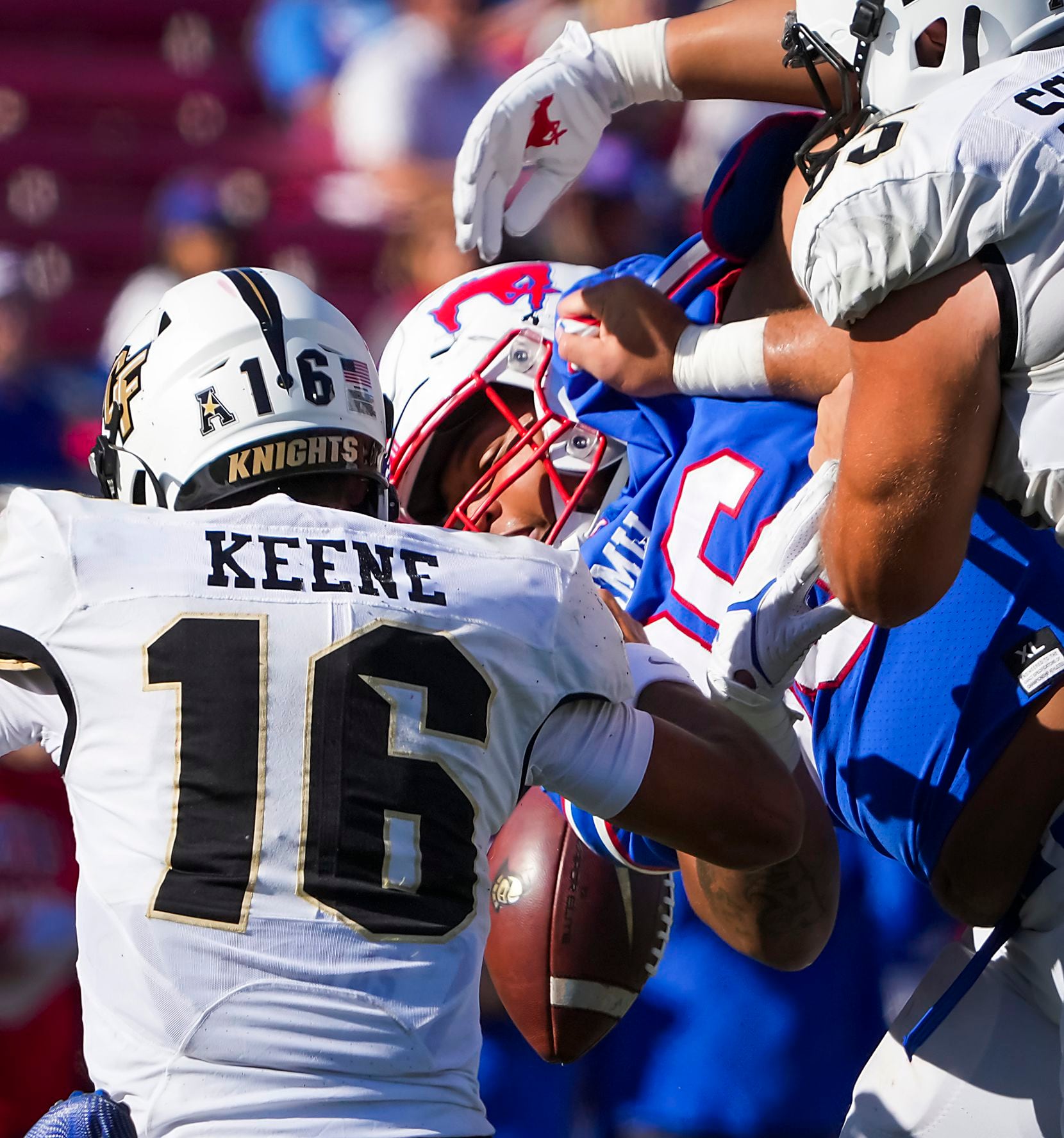 UCF quarterback Mikey Keene (16) fumbles the ball as he is hit by SMU defensive tackle...