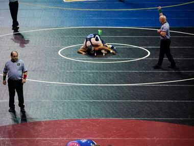 Wresters compete in a consolation round during the NCWA national championships at the Allen...