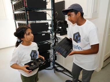 Frisco residents Aanya Thakur, 9, and her brother Ishaan, 14, discuss the computer equipment they use to mine cryptocurrency out of their garage.