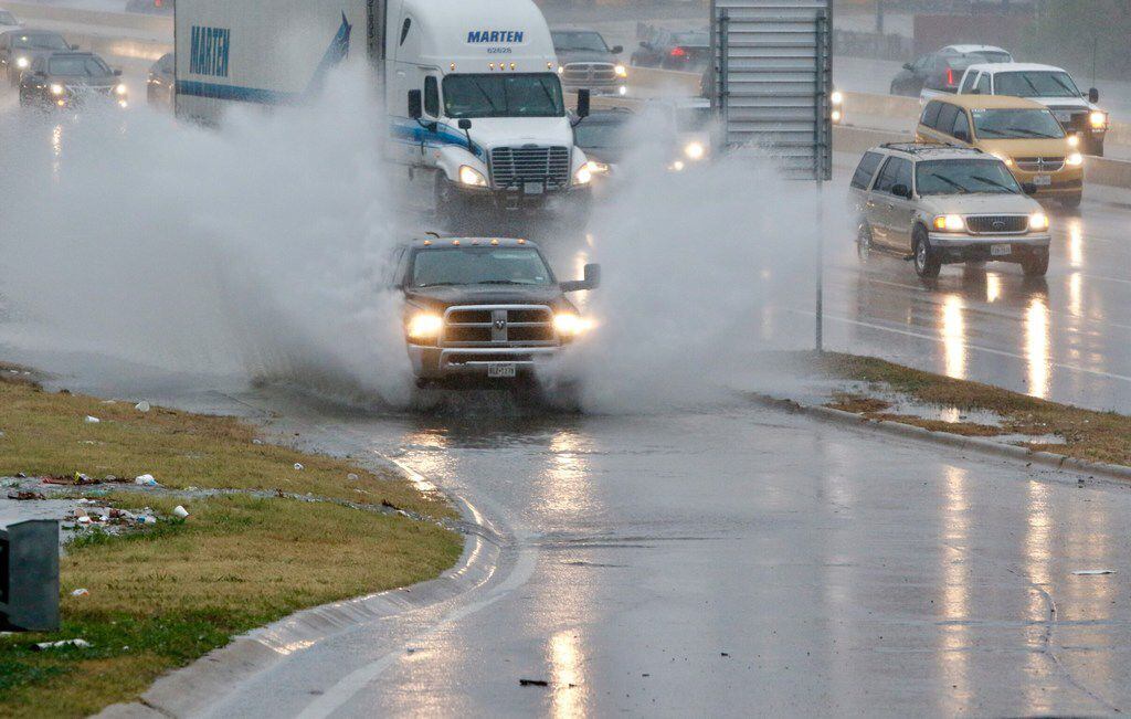 A truck splashes through standing rainwater at the Illinois Ave on north bound Interstate 35...