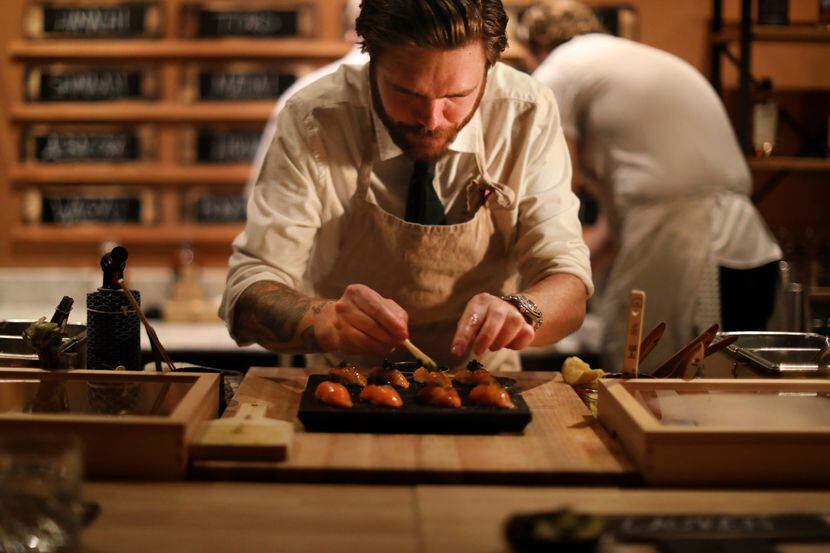 Phillip Frankland Lee prepares a course of raw fish at Sushi By Scratch, a restaurant on the...