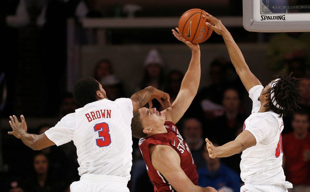 Stanford forward Reid Travis (22) attempts a shot as SMU guard Sterling Brown (3) and...