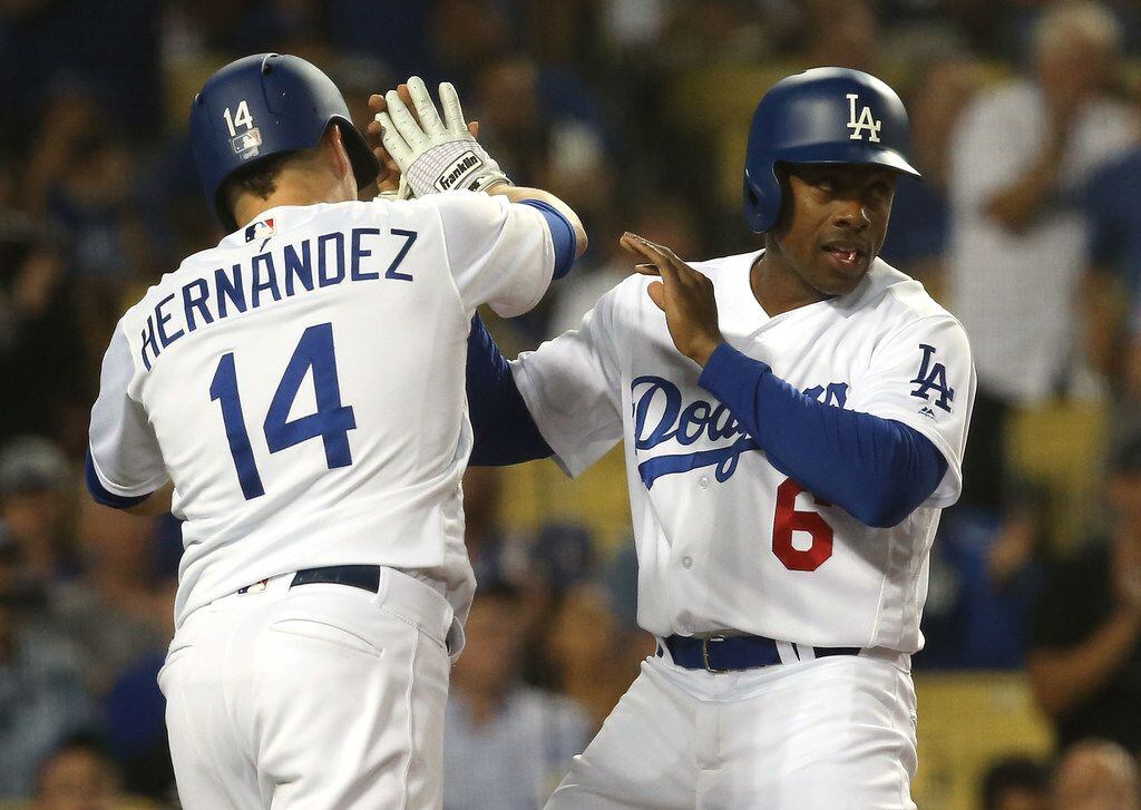 The Los Angeles Dodgers' Curtis Granderson is congratulated by teammate Kike Hernandez (14)...