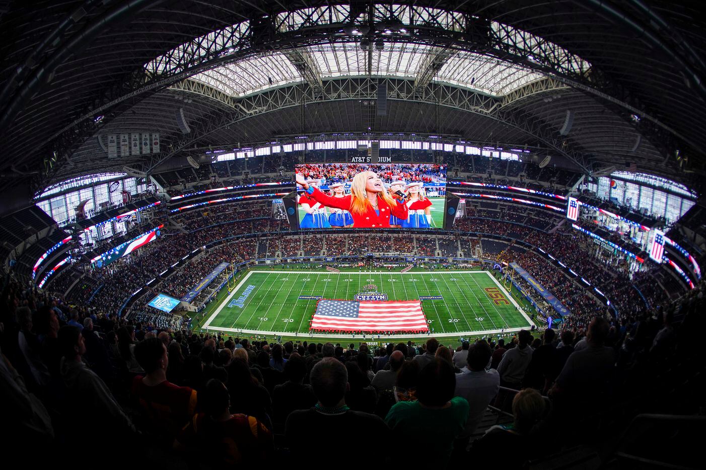 Fans stand for the national anthem before the Cotton Bowl NCAA college football game between...