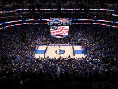 The crowd stands for the national anthem before the Dallas Mavericks faced the Utah Jazz in...