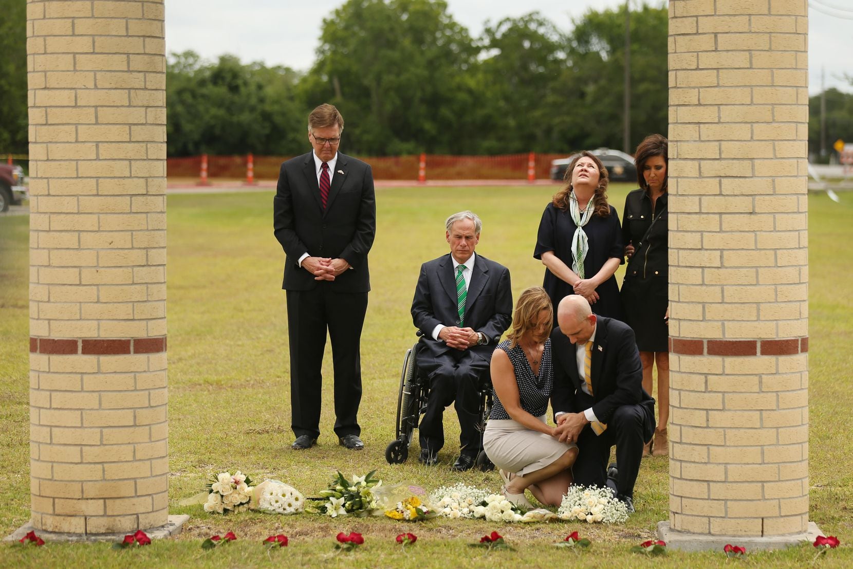 Texas Lt. Gov. Dan Patrick, Gov. Greg Abbott, and Texas first lady Cecilia Abbott pause and reflect after laying flowers at Santa Fe High School in Santa Fe, Texas Sunday May 20, 2018. On Friday morning May 18, 10 people were killed and 13 were injured after a shooting at Santa Fe High School.