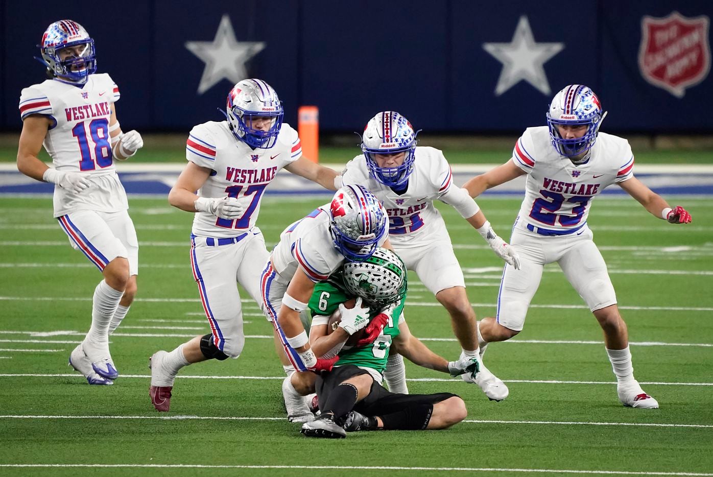 Southlake Carroll wide receiver Landon Samson (6) is brought down by Austin Westlake defensive back Michael Taaffe (14) as defensive back Ford Dickerson (18), linebacker Brady Lamme (17), defensive back Carter Barksdale (21) and defensive back Beau Breathard (23) close in on the play during the second quarter of the Class 6A Division I state football championship game at AT&T Stadium on Saturday, Jan. 16, 2021, in Arlington, Texas. (Smiley N. Pool/The Dallas Morning News)