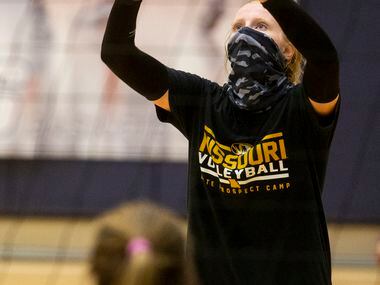 Flower Mound High School volleyball outside hitter Kaylee Cox serves the ball during...