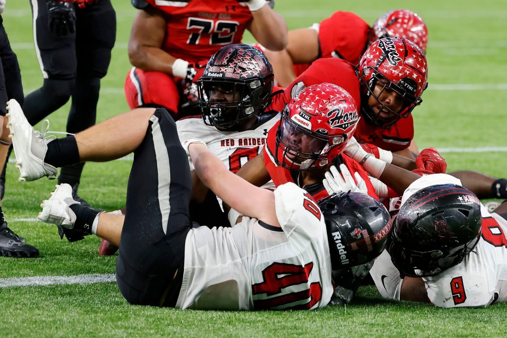 Cedar Hill quarterback scores as he is defended by Tyler legacy defenders Brooks Gallagher...