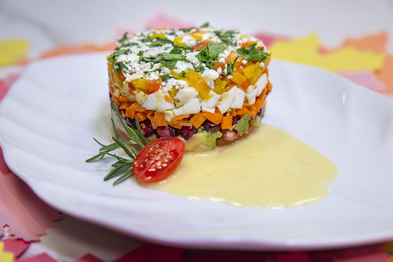 The Chopped Stack Salad is plated on a Citrus Vinaigrette and features heirloom tomatoes,...