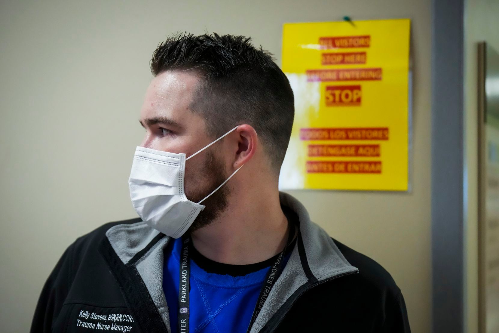 A sign on the wall behind nurse Kelly Stevens, the manager of Parkland's main COVID-19 unit,...