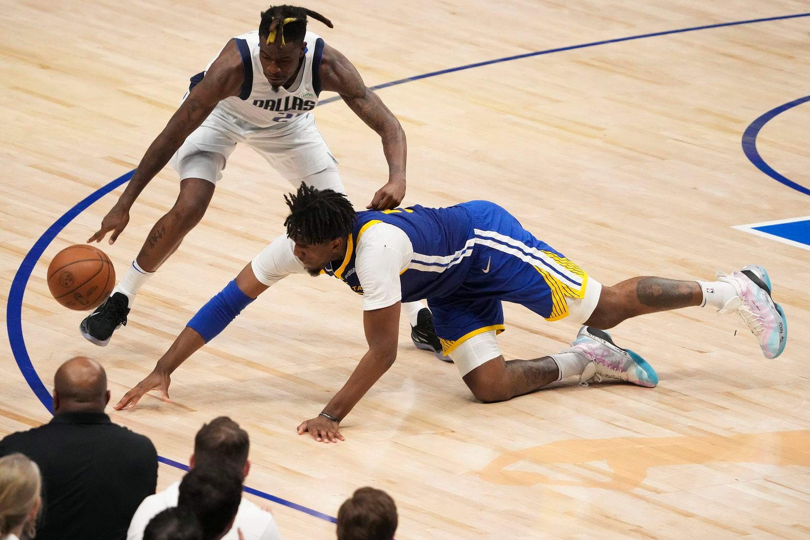 Golden State Warriors center Kevon Looney (5) turns the ball over as he tries to grab a...