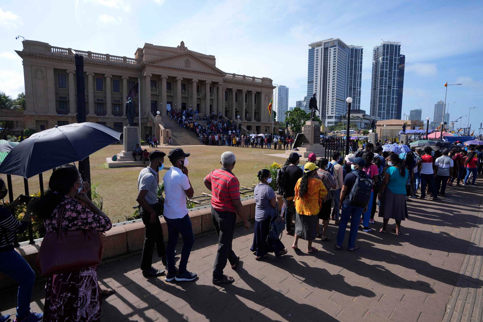 People queue up to enter the office of president Gotabaya Rajapaksa three days after it was...