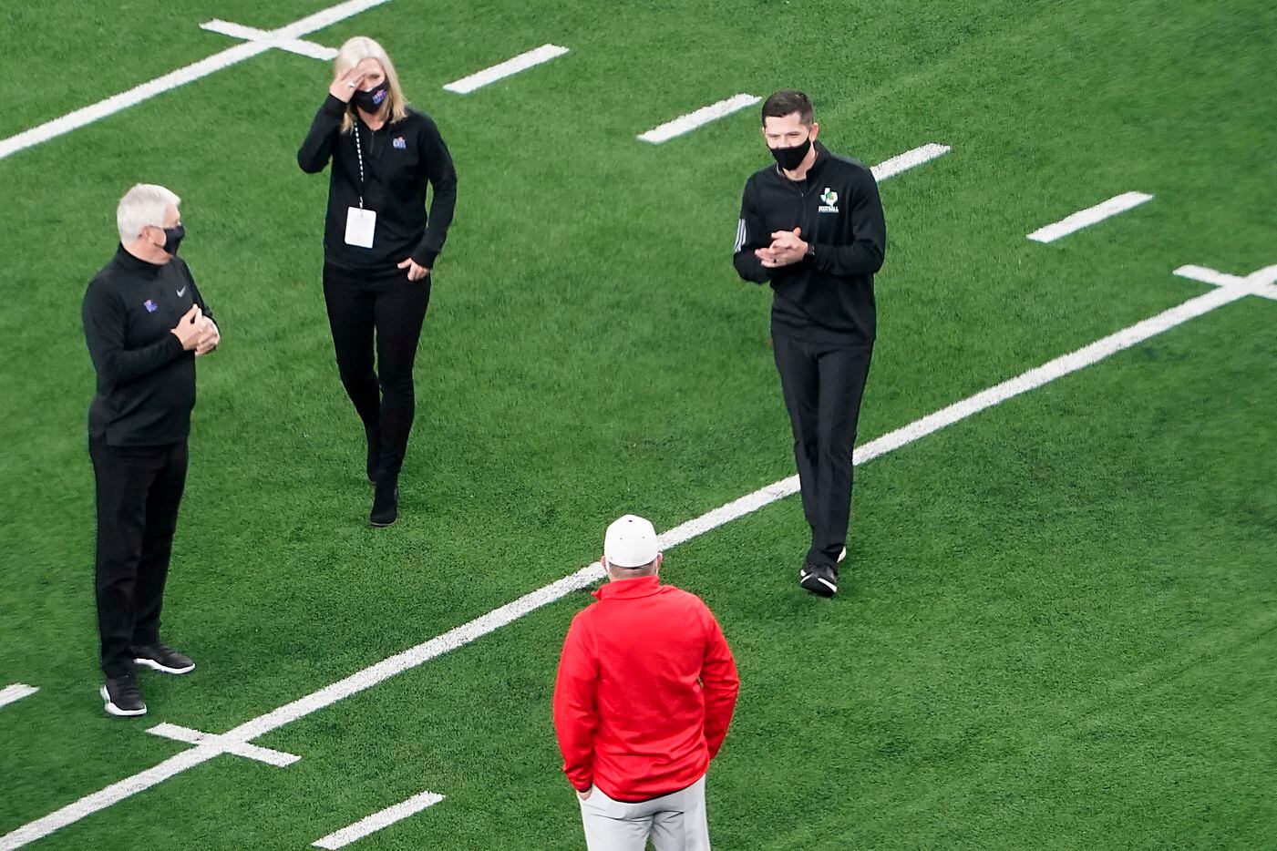 Southlake Carroll head coach Riley Dodge (top right) meets with his father, Austin Westlake head coach Todd Dodge (bottom) on the field before the two teams play for the Class 6A Division I state football championship at AT&T Stadium on Saturday, Jan. 16, 2021, in Arlington, Texas. (Smiley N. Pool/The Dallas Morning News)