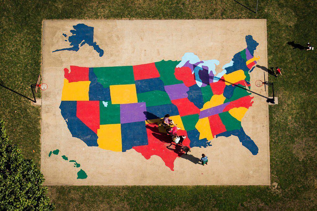 A playground map of the United Statse provides the background as adults sit near Texas and...