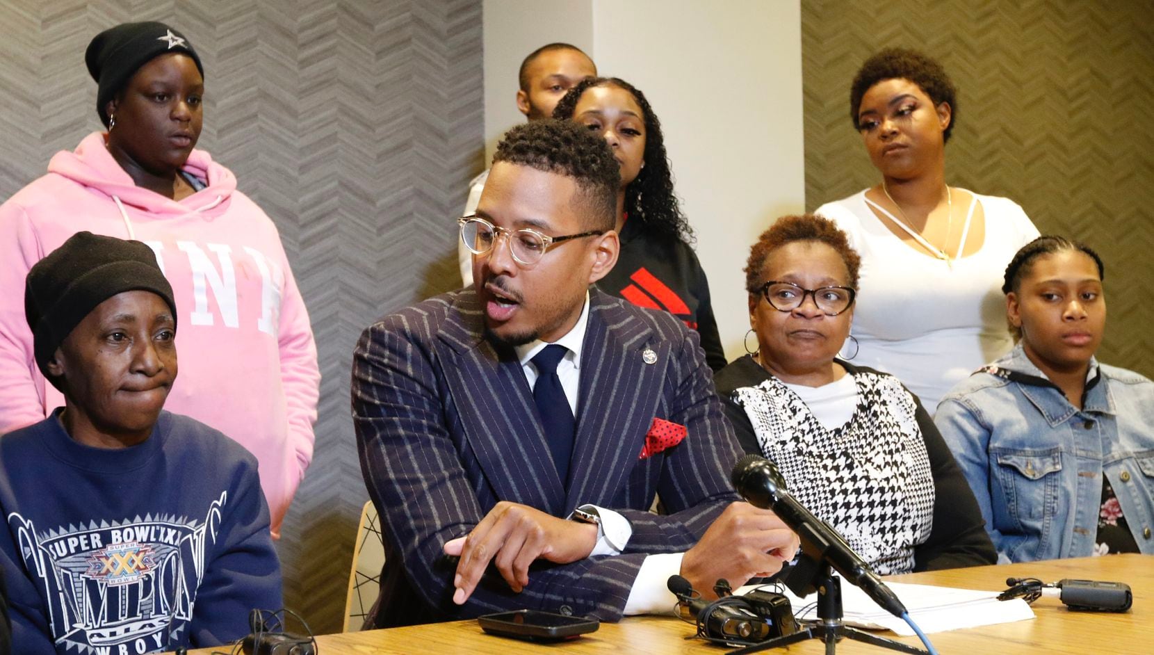 Ethelyn Ross, left, mother of Diamond Ross, and other family members listen to attorney...