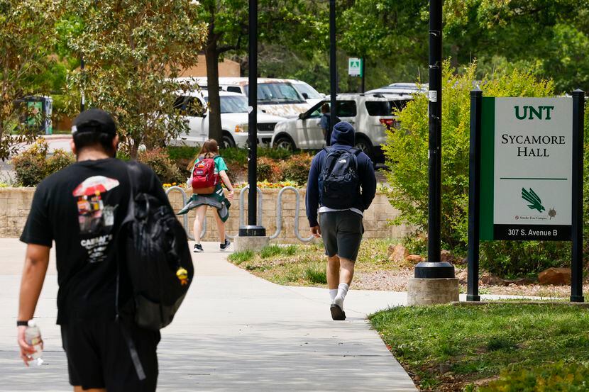 Students walk past Sycamore Hall at The University of North Texas in Denton, Texas,...