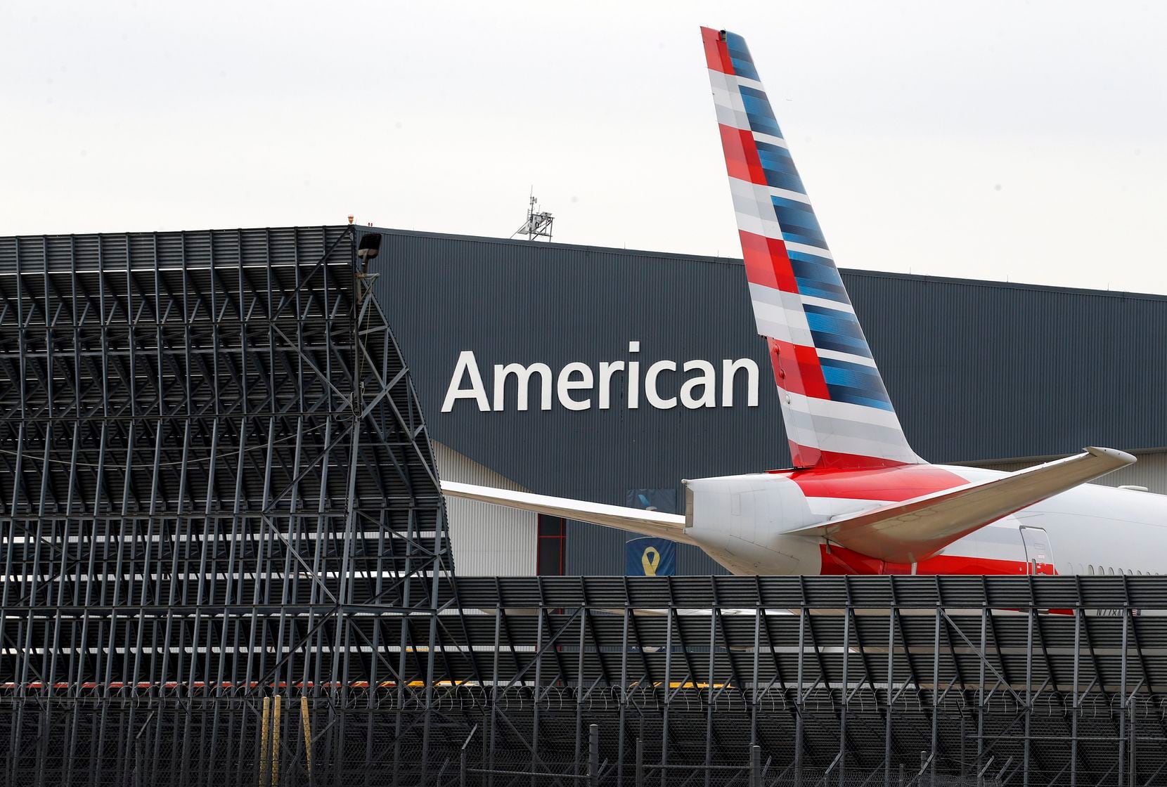 An American Airlines aircraft sits outside maintenance Hangar 5 at DFW International Airport...
